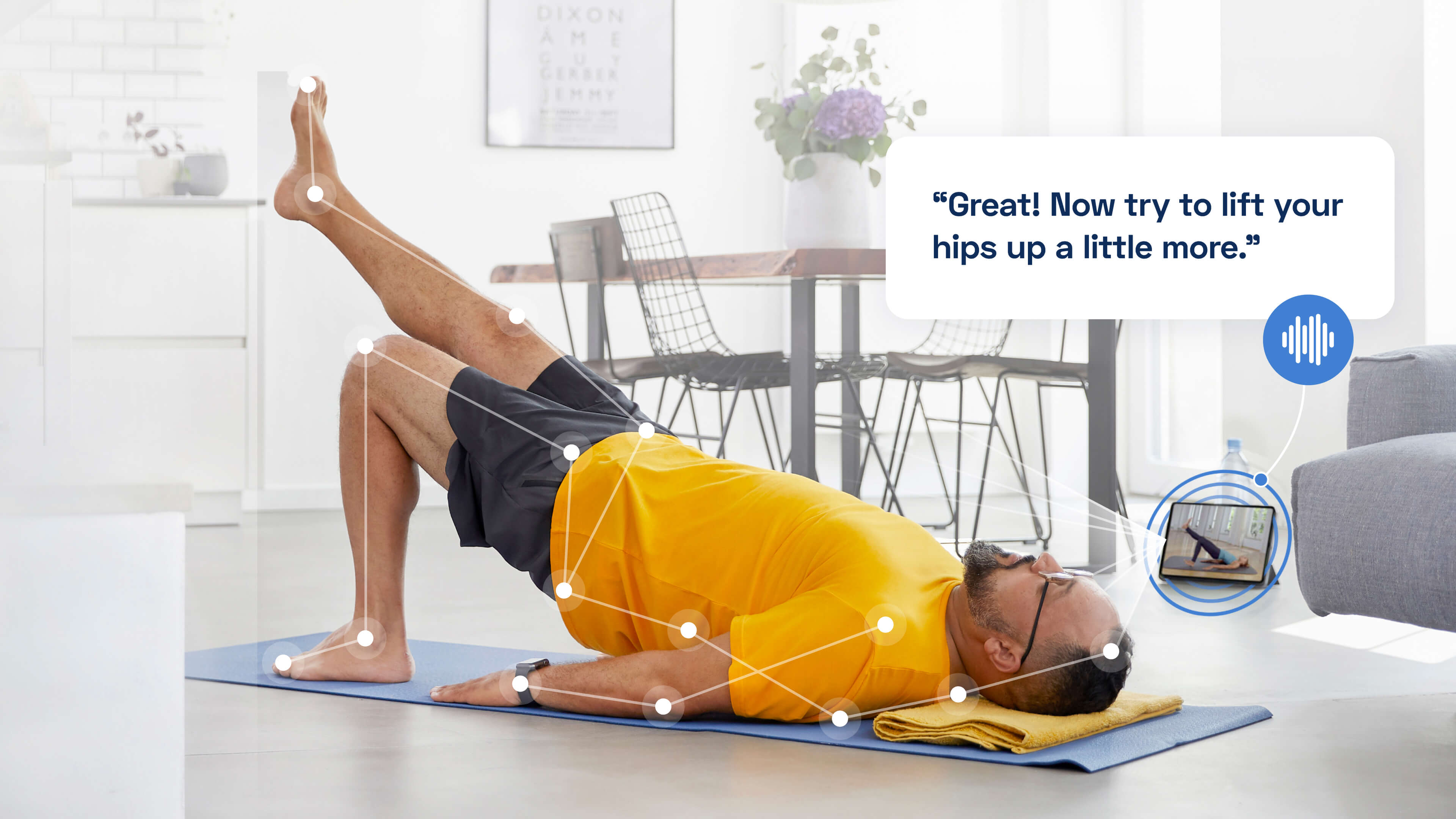 A man follows an exercise routine on a tablet while stretching on the floor.