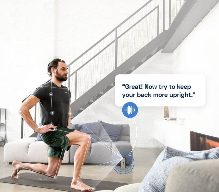 A man does lunges in his living room while following along with a program on his smartphone.